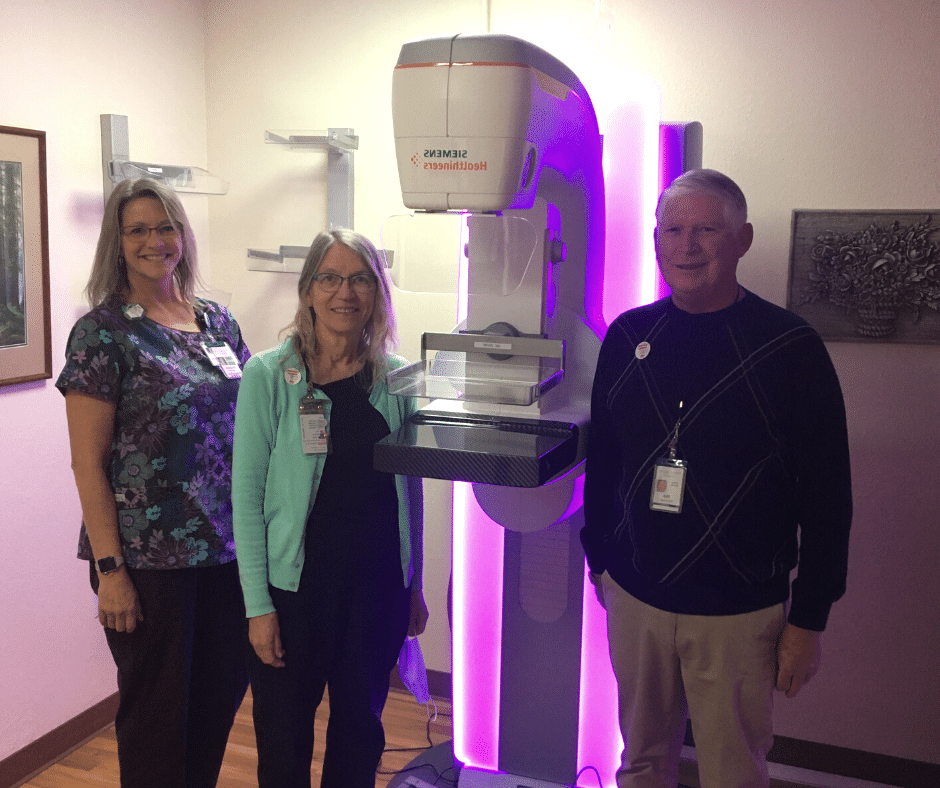 Hospital Staff members next to a Mammography machine